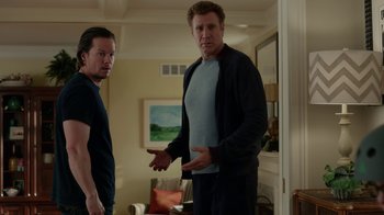 Movie still from “Daddy's Home” (2015), directed by Sean Anders – Two men standing next to each other in a living room; Medium shot, Over the shoulder angle