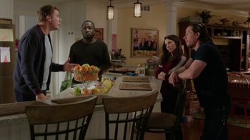 Movie still from “Daddy's Home” (2015), directed by Sean Anders – A group of people standing around a kitchen table; Medium shot, Over the shoulder angle