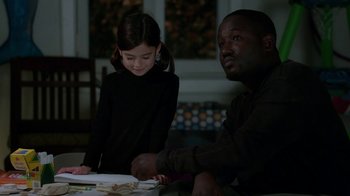 Movie still from “Daddy's Home” (2015), directed by Sean Anders – A man and a little girl sitting next to each other at a table; Medium shot, Over the shoulder angle