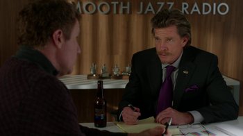 Movie still from “Daddy's Home” (2015), directed by Sean Anders – A man sitting at a table in front of another man; Medium shot, Over the shoulder angle