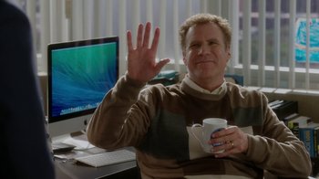 Movie still from “Daddy's Home” (2015), directed by Sean Anders – A man sitting in front of a computer holding a coffee cup; Medium shot, Over the shoulder angle