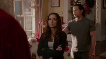 Movie still from “Daddy's Home” (2015), directed by Sean Anders – A woman standing next to a man in front of a christmas tree; Medium shot, Over the shoulder angle