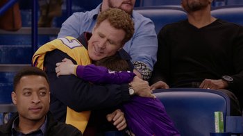 Movie still from “Daddy's Home” (2015), directed by Sean Anders – A man and a child hugging in a stadium; Medium shot, Over the shoulder angle