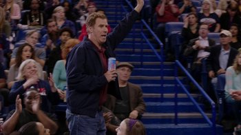 Movie still from “Daddy's Home” (2015), directed by Sean Anders – A man holding up a drink in front of an audience; Medium shot, High angle