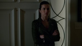 Movie still from “Daddy's Home” (2015), directed by Sean Anders – A woman standing in a room with her arms crossed; Medium shot, Over the shoulder angle