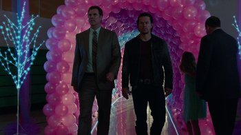 Movie still from “Daddy's Home” (2015), directed by Sean Anders – Two men in suits walking through a tunnel of balloons; Wide shot, Low angle
