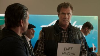 Movie still from “Daddy's Home 2” (2017), directed by Sean Anders – A man holding a sign that says " kurt mayron "; Medium shot, Over the shoulder angle