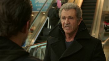 Movie still from “Daddy's Home 2” (2017), directed by Sean Anders – An older man talking to a younger man in front of an escalator; Close Up shot, Over the shoulder angle