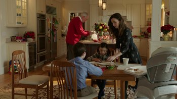 Movie still from “Daddy's Home 2” (2017), directed by Sean Anders – A woman and two children sitting at a dining table; Medium shot, High angle