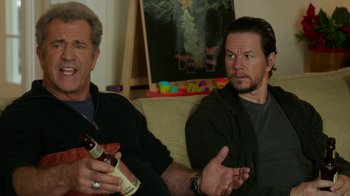 Movie still from “Daddy's Home 2” (2017), directed by Sean Anders – Two men sitting on a couch holding beer bottles; Close Up shot, Over the shoulder angle