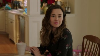 Movie still from “Daddy's Home 2” (2017), directed by Sean Anders – A beautiful young lady sitting at a table with a cup of coffee; Close Up shot, Over the shoulder angle