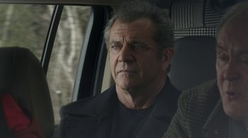 Movie still from “Daddy's Home 2” (2017), directed by Sean Anders – A man sitting in the back seat of a car; Close Up shot, Over the shoulder angle