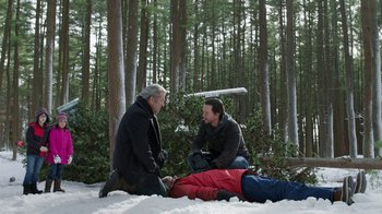 Movie still from “Daddy's Home 2” (2017), directed by Sean Anders – Two men sitting on the ground in the snow; Wide shot, High angle