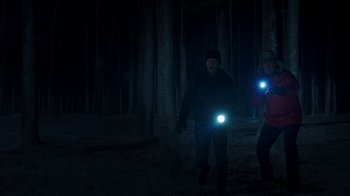 Movie still from “Daddy's Home 2” (2017), directed by Sean Anders – A man and a woman are walking through the woods at night; Wide shot, Low angle