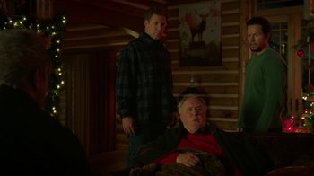 Movie still from “Daddy's Home 2” (2017), directed by Sean Anders – A man standing next to a man sitting on a couch; Medium shot, Over the shoulder angle
