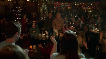 Movie still from “Daddy's Home 2” (2017), directed by Sean Anders – A group of people sitting around a room with candles; Wide shot, Over the shoulder angle