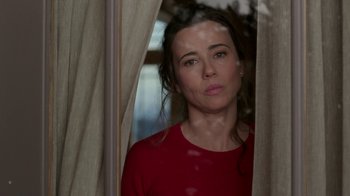 Movie still from “Daddy's Home 2” (2017), directed by Sean Anders – A woman in a red shirt looking out of a window; Close Up shot, Over the shoulder angle