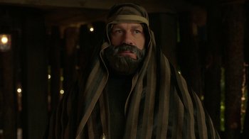 Movie still from “Daddy's Home 2” (2017), directed by Sean Anders – A man with a beard wearing a robe and a beard; Medium shot, Over the shoulder angle