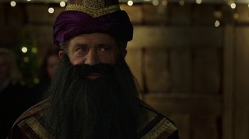 Movie still from “Daddy's Home 2” (2017), directed by Sean Anders – A man with a long beard wearing a purple hat; Close Up shot, Over the shoulder angle