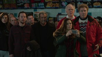 Movie still from “Daddy's Home 2” (2017), directed by Sean Anders – A woman taking a picture of a group of people; Medium shot, Over the shoulder angle