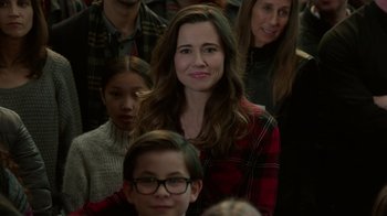 Movie still from “Daddy's Home 2” (2017), directed by Sean Anders – A group of people sitting in a room with a woman; Medium shot, Over the shoulder angle