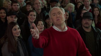 Movie still from “Daddy's Home 2” (2017), directed by Sean Anders – An older man in a red sweater is pointing at the crowd; Medium shot, High angle