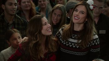 Movie still from “Daddy's Home 2” (2017), directed by Sean Anders – Two women smiling for the camera in front of a group of people; Close Up shot, Over the shoulder angle