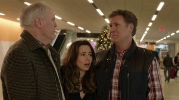 Movie still from “Daddy's Home 2” (2017), directed by Sean Anders – Two men and a woman standing next to each other in front of a christmas tree; Medium shot, Over the shoulder angle