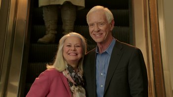 Movie still from “Daddy's Home 2” (2017), directed by Sean Anders – An older man and woman posing for a picture; Medium shot, Low angle