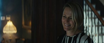 Movie still from “Daniel Isn't Real” (2019), directed by Adam Egypt Mortimer – A woman smiling for the camera in front of a window; Close Up shot, Over the shoulder angle