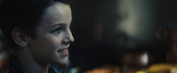 Movie still from “Daniel Isn't Real” (2019), directed by Adam Egypt Mortimer – A woman's face in a dimly - lit room; Close Up shot, Over the shoulder angle