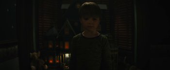 Movie still from “Daniel Isn't Real” (2019), directed by Adam Egypt Mortimer – A young boy standing in a dark room; Medium shot, Low angle