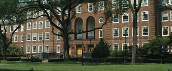 Movie still from “Daniel Isn't Real” (2019), directed by Adam Egypt Mortimer – A building with a tree in front of it; Extreme Wide shot, Low angle