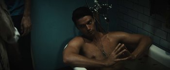 Movie still from “Daniel Isn't Real” (2019), directed by Adam Egypt Mortimer – A shirtless man in a bathroom taking a shower; Medium shot, High angle