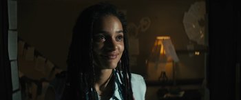Movie still from “Daniel Isn't Real” (2019), directed by Adam Egypt Mortimer – A woman with dreads is smiling for the camera; Close Up shot, Low angle