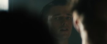 Movie still from “Daniel Isn't Real” (2019), directed by Adam Egypt Mortimer – A man's face in a dark room; Close Up shot, Over the shoulder angle