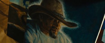 Movie still from “Daniel Isn't Real” (2019), directed by Adam Egypt Mortimer – An oil painting of a man wearing a cowboy hat; Close Up shot, Low angle