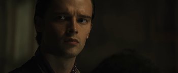 Movie still from “Daniel Isn't Real” (2019), directed by Adam Egypt Mortimer – A man's face in the dark; Close Up shot, Low angle