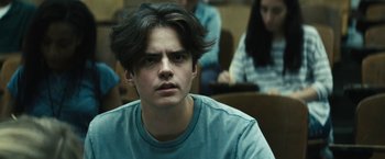 Movie still from “Daniel Isn't Real” (2019), directed by Adam Egypt Mortimer – A young man sitting in front of a group of people; Close Up shot, Over the shoulder angle