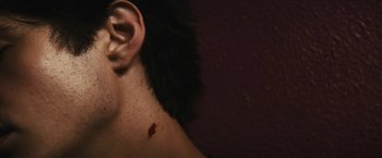 Movie still from “Daniel Isn't Real” (2019), directed by Adam Egypt Mortimer – A man's ear with a bullet hole in it; Extreme Close Up shot, High angle