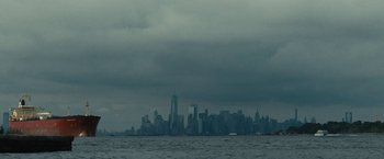 Movie still from “Daniel Isn't Real” (2019), directed by Adam Egypt Mortimer – A view of a city skyline from the water; Extreme Wide shot, Low angle