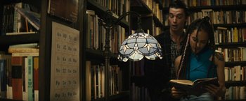 Movie still from “Daniel Isn't Real” (2019), directed by Adam Egypt Mortimer – A man standing in front of a book shelf; Medium shot, Over the shoulder angle