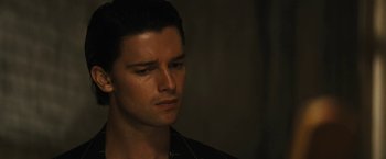 Movie still from “Daniel Isn't Real” (2019), directed by Adam Egypt Mortimer – A person wearing a black shirt; Close Up shot, Over the shoulder angle