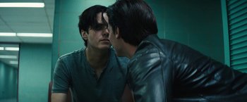 Movie still from “Daniel Isn't Real” (2019), directed by Adam Egypt Mortimer – A man looking at his reflection in a mirror; Close Up shot, Over the shoulder angle