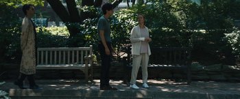 Movie still from “Daniel Isn't Real” (2019), directed by Adam Egypt Mortimer – Two people standing on a bench in a park; Wide shot, Low angle