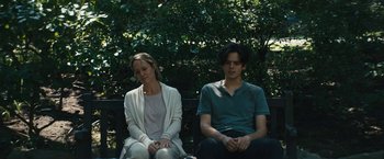 Movie still from “Daniel Isn't Real” (2019), directed by Adam Egypt Mortimer – A woman and a man sitting next to each other on a park bench; Medium shot, Over the shoulder angle