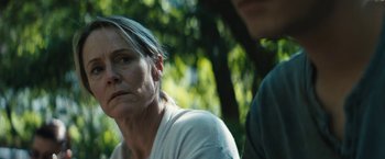 Movie still from “Daniel Isn't Real” (2019), directed by Adam Egypt Mortimer – A woman sitting next to a man in a park; Close Up shot, Over the shoulder angle