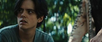 Movie still from “Daniel Isn't Real” (2019), directed by Adam Egypt Mortimer – A young man's face with trees in the background; Close Up shot, Low angle