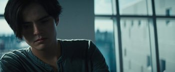 Movie still from “Daniel Isn't Real” (2019), directed by Adam Egypt Mortimer – A man sitting in front of a large window; Close Up shot, Over the shoulder angle