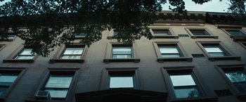 Movie still from “Daniel Isn't Real” (2019), directed by Adam Egypt Mortimer – A building with a tree in front of it; Extreme Wide shot, Low angle